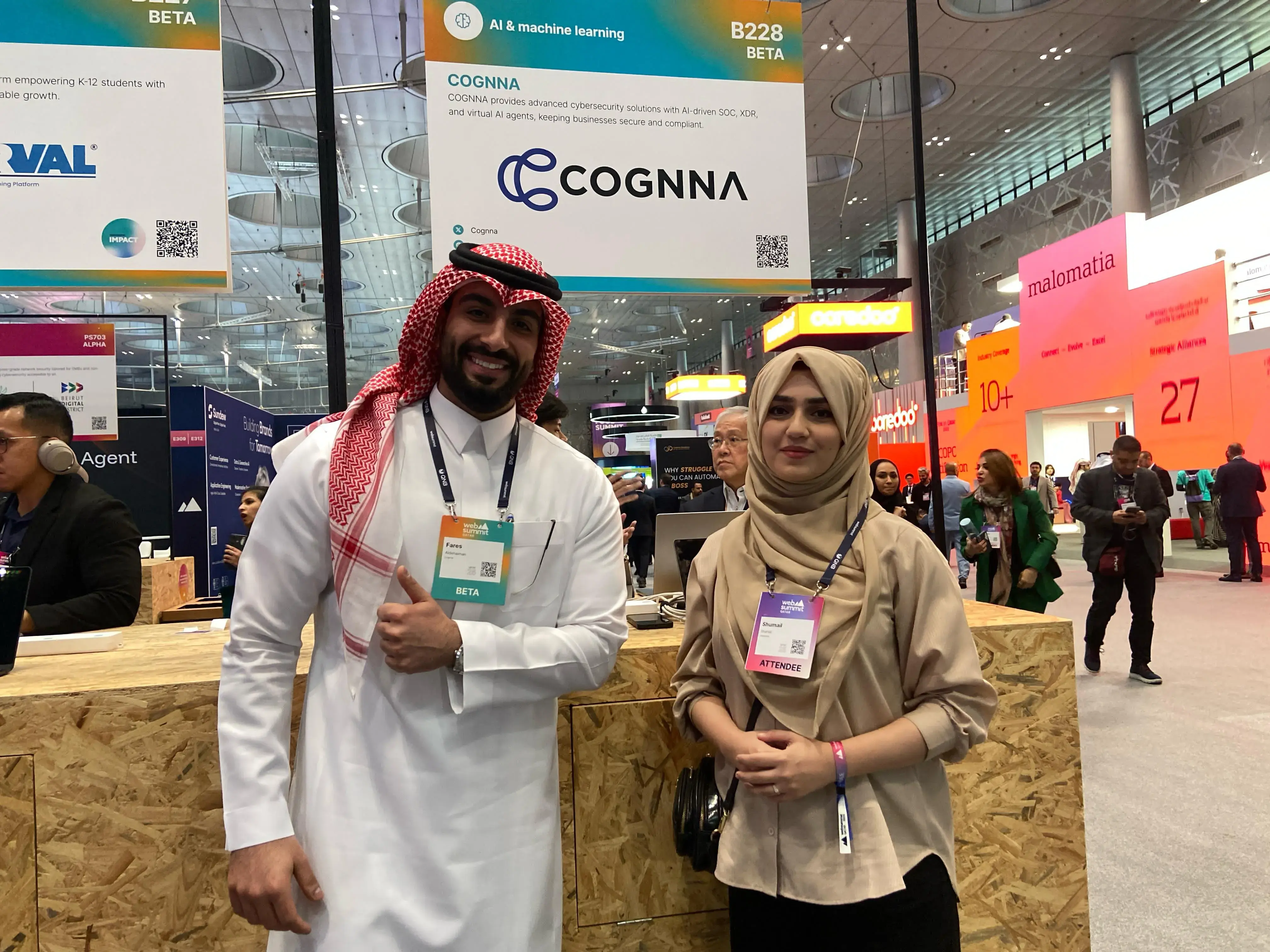 Grayphite team member with an exhibitor at Web Summit Qatar